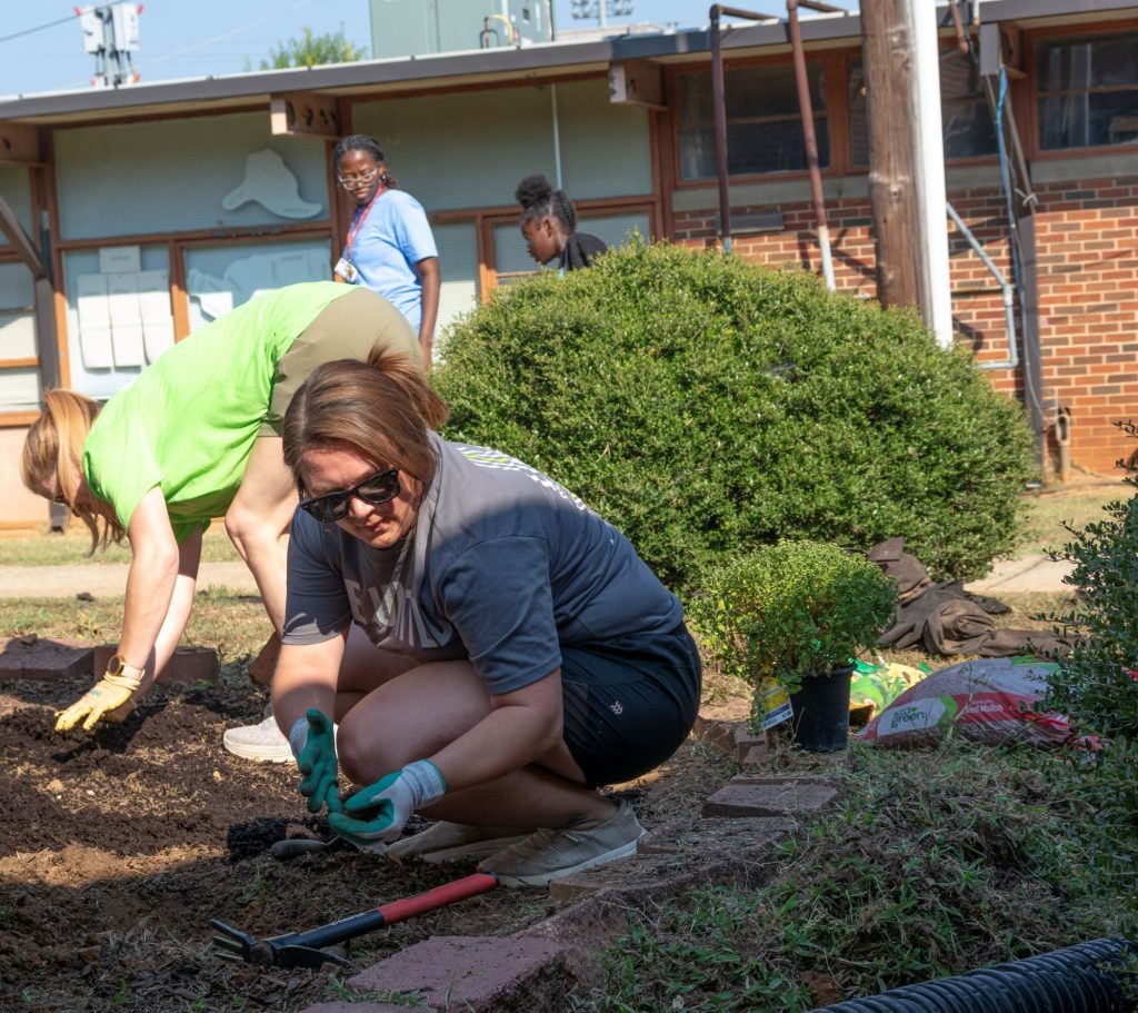 Regions employee volunteering at CJ Donald Middle School as part of Regions Evergreen Week.